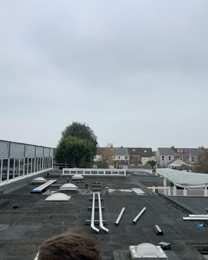 Insulated and labelled stainless steel heating pipework inside a school