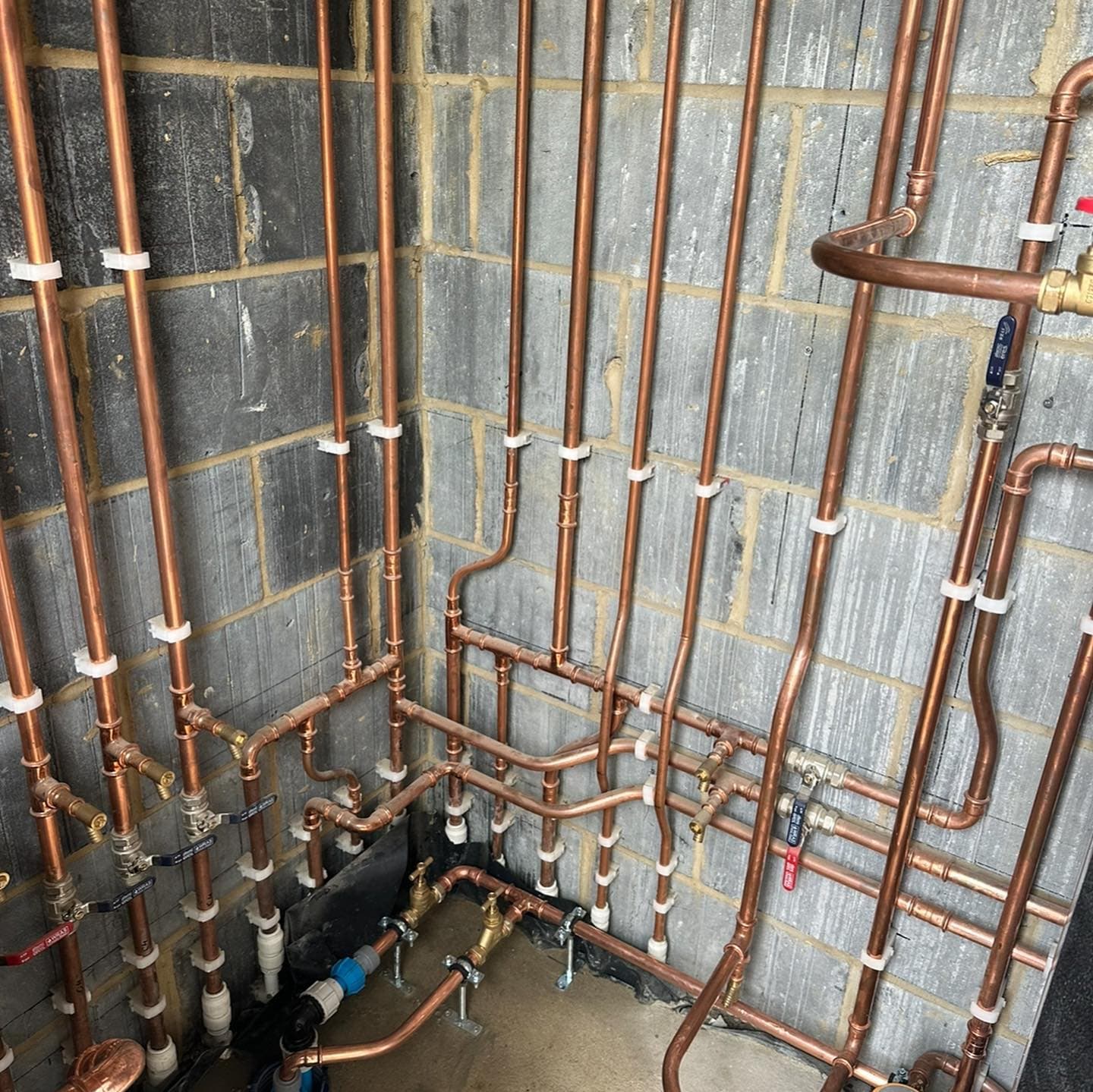 Copper pipework in a new-build plant room, one of six Vaillant AroTherm installations at a Twineham development