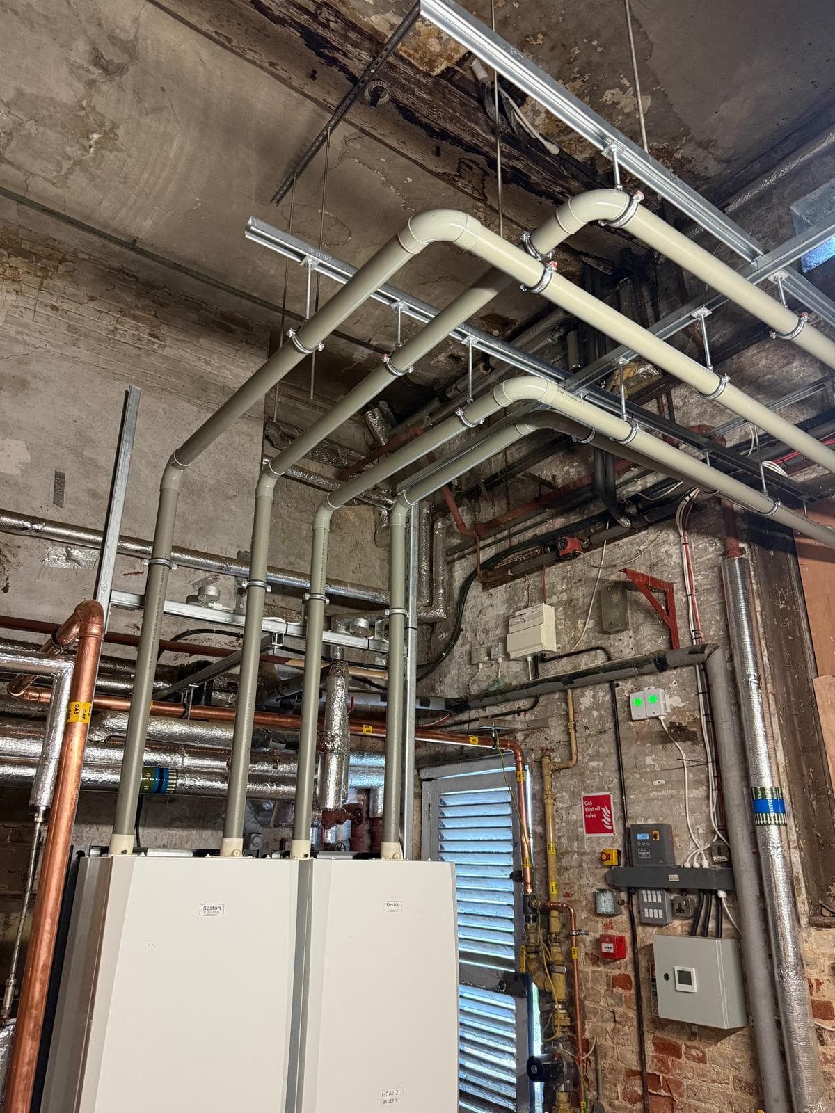 Flue runs from two Keston boilers up and across an old brick ceiling