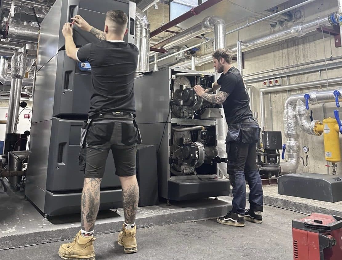 Spitfire Commercial engineers working on a large commercial boiler in a plant room
