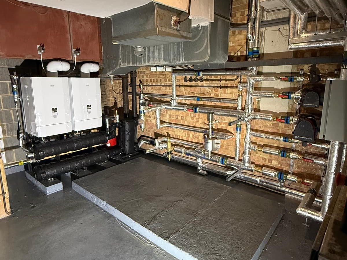 New plant room in a Brighton synagogue with two Ideal Evomax boilers in cascade and a labelled pump wall